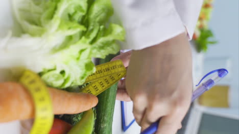 Vertical-video-of-Research-dietitian.-Examines-vegetables-and-takes-notes.